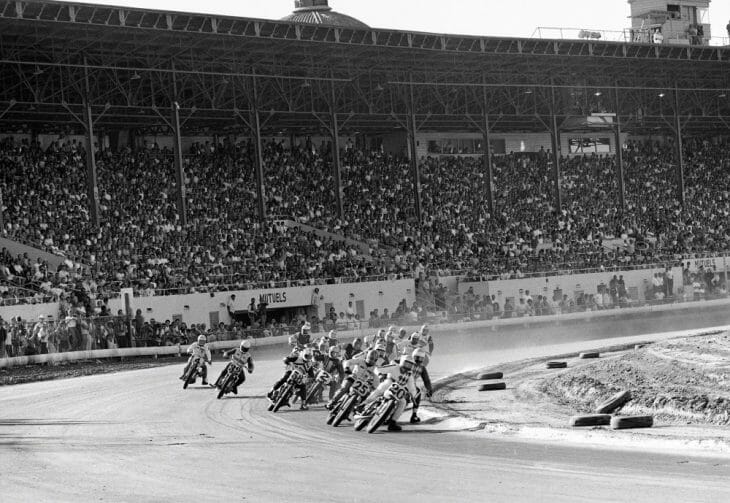 Gene Romero leading the pack into the first turn in front of a packed grandstands at the 1969 Sacramento Mile. 