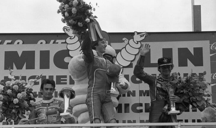 Franco Uncini looks none to thrilled with Freddie Spencer’s first GP victory, while Barry Sheene looks fine with it. (Henny Ray Abrams photo)