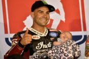 Jared Mees on the podium with his baby after winning the AFT National in Elbridge, NY