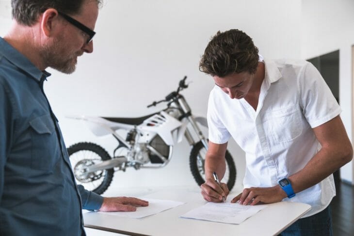 Ty Tremaine signs his Alta Motors contract along with Alta co-founder, Derek Dorrestyn. 