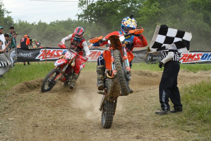 Kailub Russell wheelies over the finish.