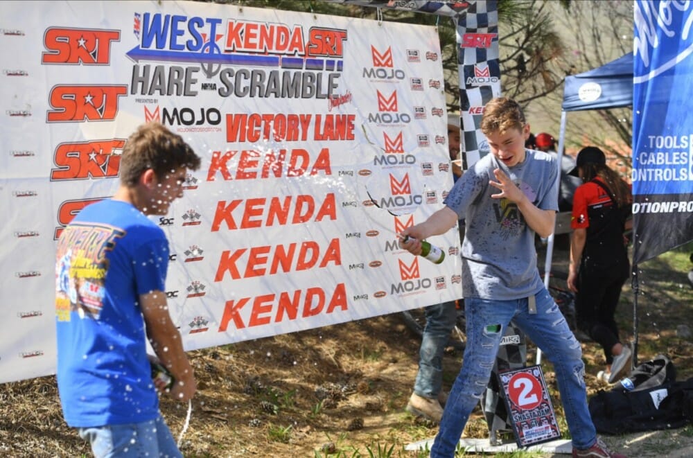 Talon Terlouw and Italo Ruggiero spray cider on the Big Wheel podium. Terlouw topped the podium with Ruggiero in 2nd and Lane Forbes in 3rd. 
