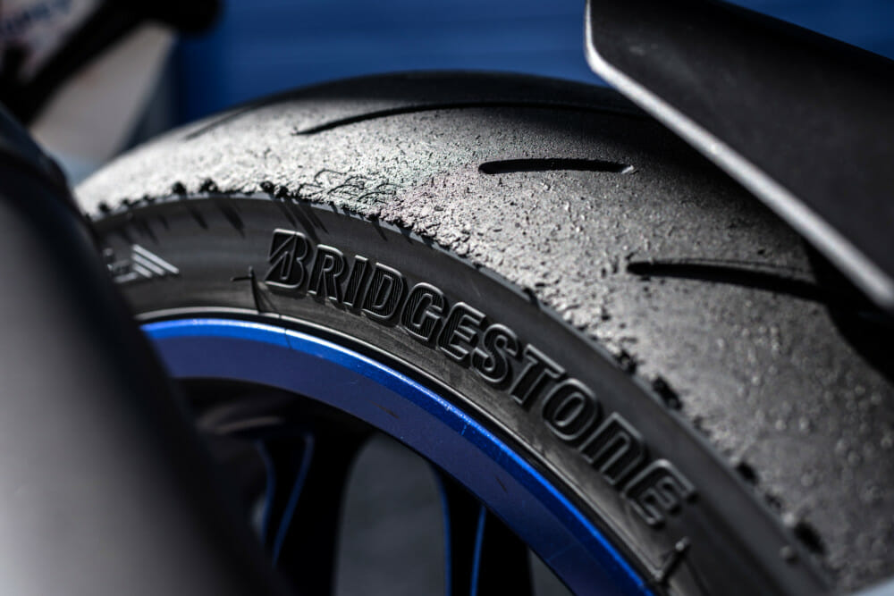 More grooves mean better wet grip, but also gives less slippage under full load as the tire molds to the tarmac.