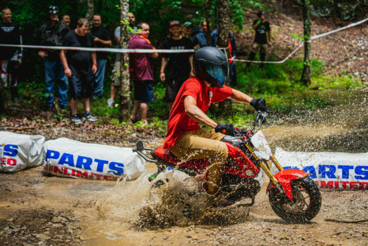 A rider splashing through the water at the 2019 Barber Small Bore event.