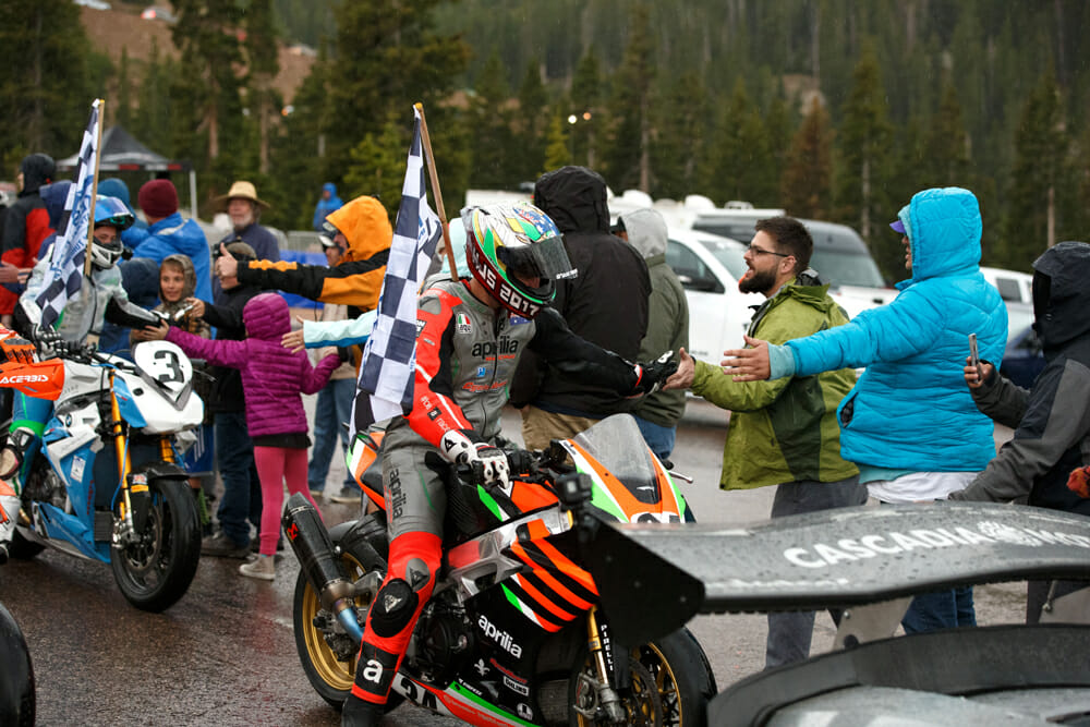 Rennie and second placed Lucy Glockner share the spoils of the crowd, who braved rain, hail and even snow to be there on race day.