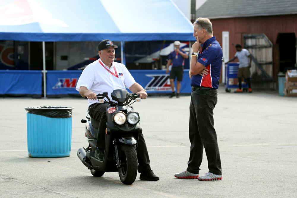 Chuck Aksland (left) and MotoAmerica Physical Therapist James Buskirk in a discussion.