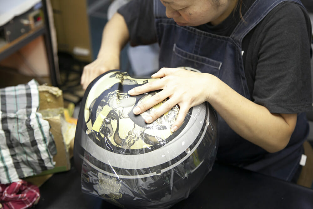 adding the graphics to a helmet on Cycle News' Arai Factory Tour