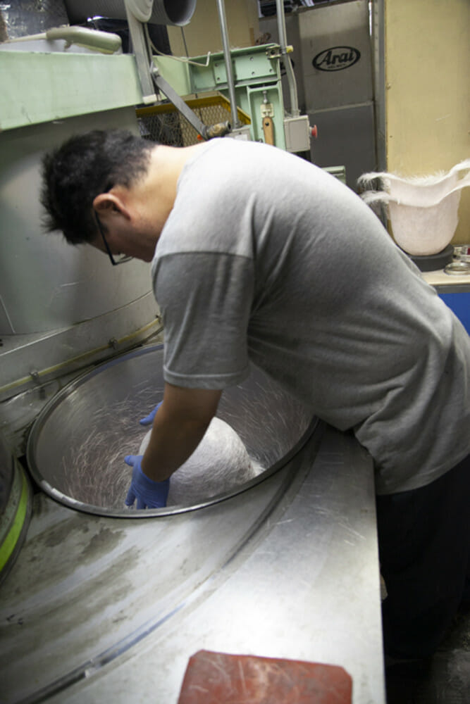 Fiberglass and Superfiber are blasted onto a dome the shape of a human head to create something similar to a bird’s nest, known as the preforma, which will form the basis for any Arai shell.