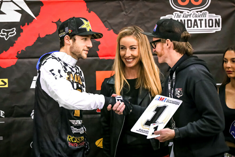 Colton Haaker accepts his latest number-one plate from AMA Off-Road Racing Manager Erek Kudla and EnduroCross announcer Laurette Nicoll.