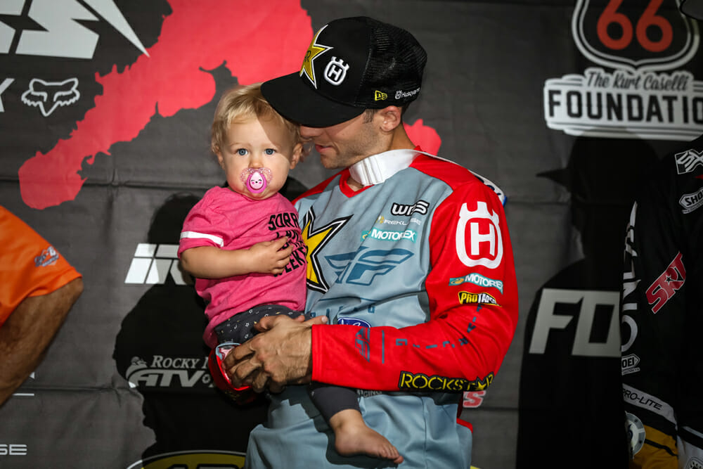 Colton Haaker shows off his daughter, London, on the podium.