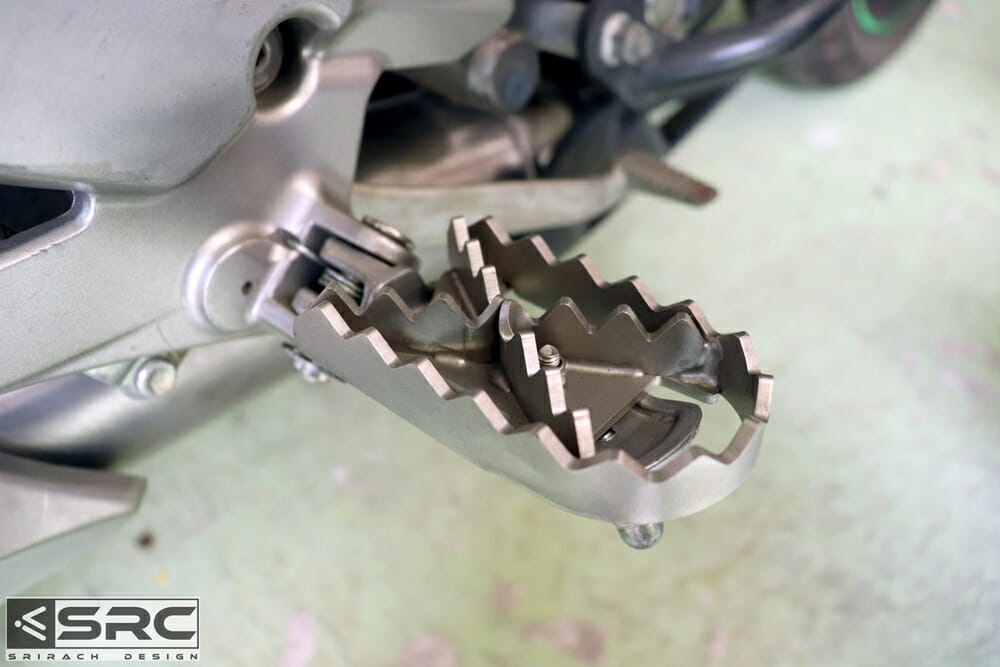 The SRC Moto wide footpeg adaptor installed on a Kawasaki Versys 650.