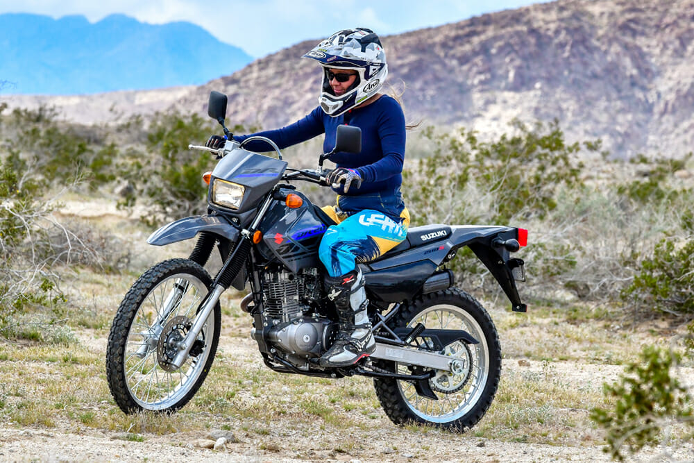 Shawna smiling while learning to ride a motorcycle.
