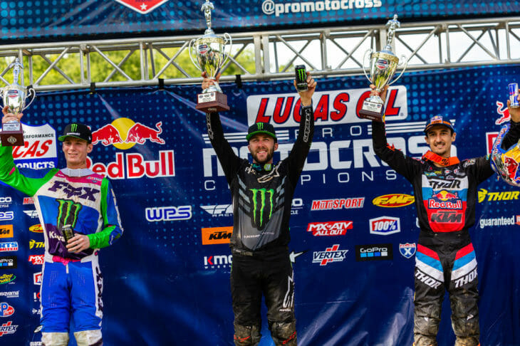  It was a good day for defending 450MX Champion Eli Tomac at the Ironman National Motocross in Crawfordsville, Indiana, August 29. The Monster Energy Kawasaki rider managed to take a big chunk out of Zach Osborne’s lead in the championship after going 2-1 on the day for the overall win, which he had to fight for. The first moto, however, was all Marvin Musquin’s on the Red Bull KTM. It was a year ago to almost the day that Musquin injured his knee at this very track that resulted in him sitting out the entire 2020 Supercross season. He put that disaster out of his head in a big way and dominated the first moto with a wire-to-wire win, but there was still plenty of action to watch behind him. Tomac, who wanted to finish ahead of Osborne at all cost, got away in second but had Osborne right behind him and was threatening the Kawasaki rider for the position—and did so for a long time. But a run-in with a lapper and a bout with arm-pump eventually got the best of Osborne who slipped back to sixth by moto’s end. Tomac finished a distant second to Musquin, followed by Adam Cianciarulo (Monster Energy Kawasaki) and a hard-charging Chase Sexton (Honda HRC). Osborne wanted to get some of those points back in the second moto and darted into the lead to start the second moto ahead of Cianciarulo and Tomac. Cianciarulo, who could taste his first 450MX-class win, got around Osborne on the third lap and tried sprinting away, but Osborne stayed with him for a while before changing his attention to Tomac, who was on the attack right behind him. Tomac eventually got around Osborne, and then his teammate, Cianciarulo, but wasn’t out of the woods just yet. Seemingly out of nowhere, Justin Barcia (Monster Energy Yamaha) made his way up through the pack and started challenging Tomac for the lead! Barcia chased Tomac for the last four laps but couldn’t find an opening he needed to make the pass. Tomac took the moto win just 1.103 seconds ahead of Barcia and another 20 seconds ahead of third-place Osborne. Cianciarulo slipped back to fourth, followed by Sexton and first-moto winner Musquin, who got off to a bad start and later admitted that he just didn’t have the intensity that some of the riders ahead of him had in that moto. Musquin’s 1-6 still gave him second overall, with a 3-4 getting Cianciarulo on the podium for the second week in a row. Barcia, sixth in the first moto, ended up fourth overall, while a 6-2 got Osborne fifth. In the championship, Tomac pulled 13 points on Osborne, who is still on top of the leaderboard with 122 points. Musquin is second with 109, followed by Barcia with 96 and Tomac with 95. After pulling out of the first moto, Jason Anderson did not start the second, complaining of pain in his arm from an earlier injury. Max Anstie also retired early with an injury from a second-moto crash. In the 250MX class, it was another frustrating day for points leader Ferrandis who was clearly the fastest rider on the track but didn’t come away with the win, which instead went to his nearest rival in the championship Jeremy Martin. Ferrandis was in a class of his own in the first moto. He chose the far inside on the starting gate and made it work by grabbing the early lead and running off with the win. And no one was close. The Monster Energy/Star Racing Yamaha team rider eventually took the checkered flag 26 seconds ahead of Martin, who started right behind Ferrandis off the start but just couldn’t match Ferrandis’ speed. Brandon Hartranft (Troy Lee Designs/Red Bull KTM) was third, followed by Jett Lawrence (Geico Honda), and RJ Hampshire (Rockstar Energy Husqvarna), who were all fairly spread out as the top five crossed the finish line. Shan McElrath, however, was right behind Hampshire, who was just ahead of Alex Martin, Justin Cooper and Cameron McAdoo. Going into the second moto, Ferrandis looked to be in good shape to get the overall win based on his performance in the first moto, but a first-turn crash that involved his teammate McElrath, McAdoo and a couple of other riders, put Ferrandis to the back of the 40-rider field while Martin got away out in front, which was bad news for Ferrandis. Martin went on to win the moto, but all eyes were focused on Ferrandis, who had no shot at the overall victory but needed to minimize the damage as best he could. Ferrandis quicky worked his way up through the field, passing riders in bunches in the early half of the race. Late in the race, Ferrandis made a couple of big passes on Jett Lawrence and Brandon Hartranft to get third in the moto, finishing just 10 seconds behind winner Martin and five seconds behind runner-up Cooper. So, what could’ve been a disaster of a day for Ferrandis ended up not being so bad. He somehow managed to retain the red plate as the points leader. However, his lead did shrink a little bit, but it could’ve been much worse for the Frenchman. He now leads Martin by four points with three of nine rounds in the books. Alex Martin, sixth overall on the day, is 31 points in back of his younger brother in third. McElrath is another five points back in fourth. Hampshire (5-17), who was fast and aggressive all day but the victim of a second-moto crash, holds down fifth in the championship, five pints behind McElrath. CN